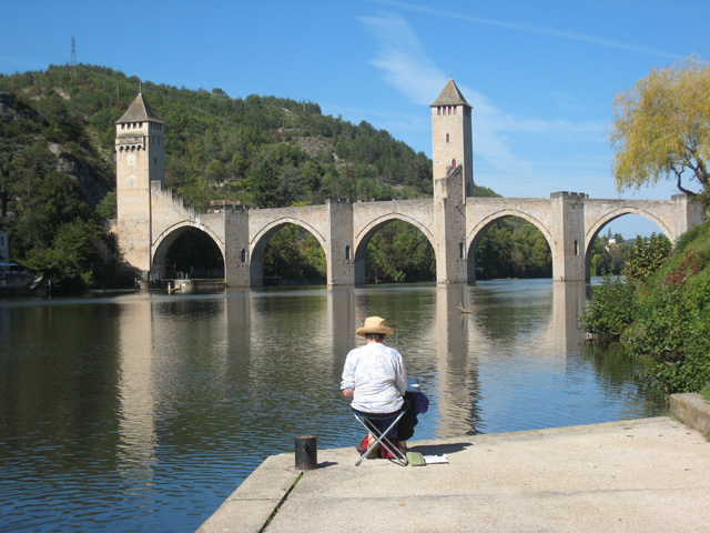 An artist viewing a bridge during Susie Home's painting holiday in France based at Le Perchoir des Paons
