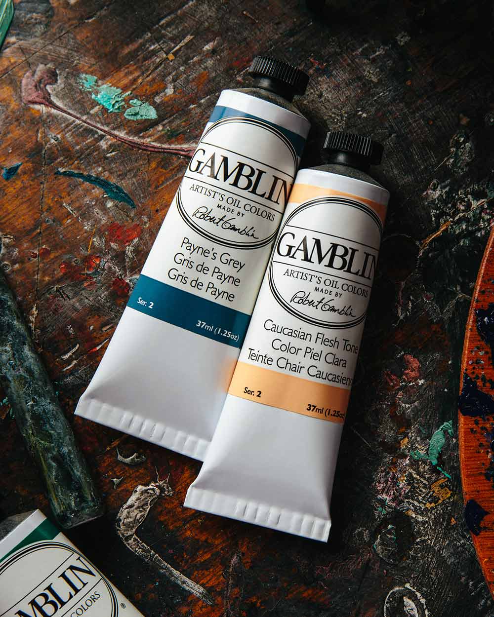 Gamblin paint tubes on a dark studio table