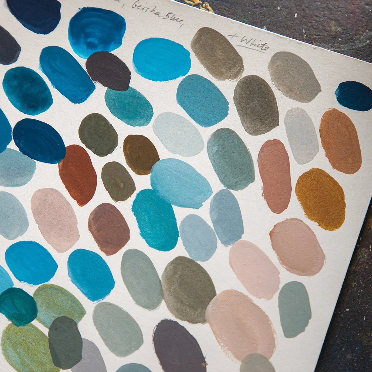 Holbein Artists Gouache Winter Palette swatched out on an artists paper