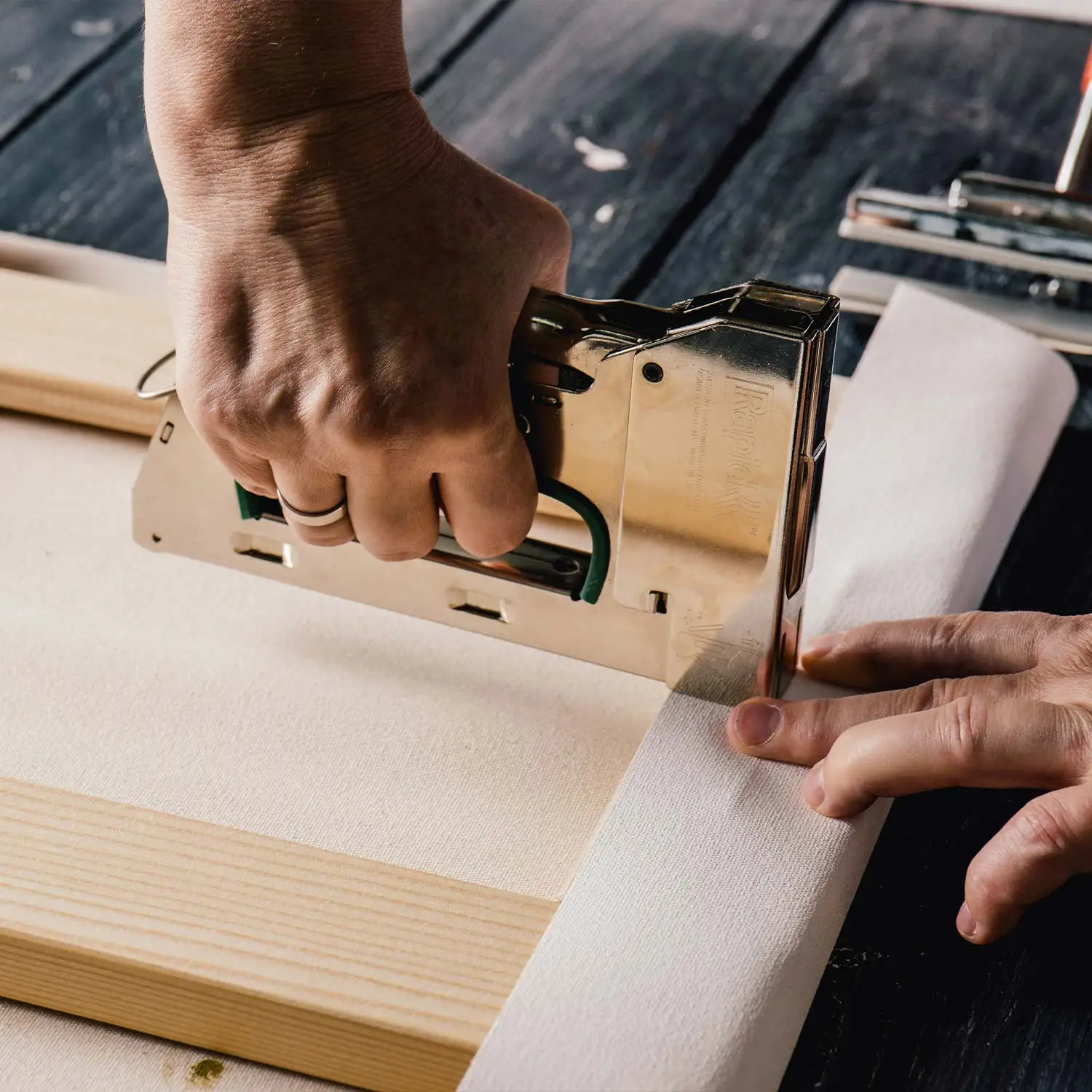 Stapler stapling a Jackson's canvas in an artist studio