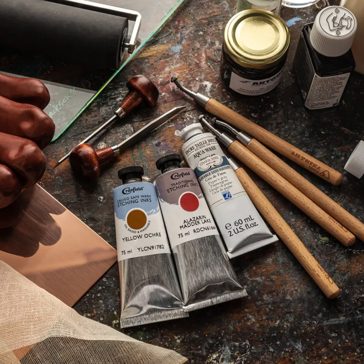 Cranfield etching inks, etching tools and materials on a studio table