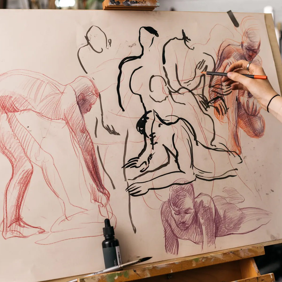 Life drawing of figures on a easel in a studio