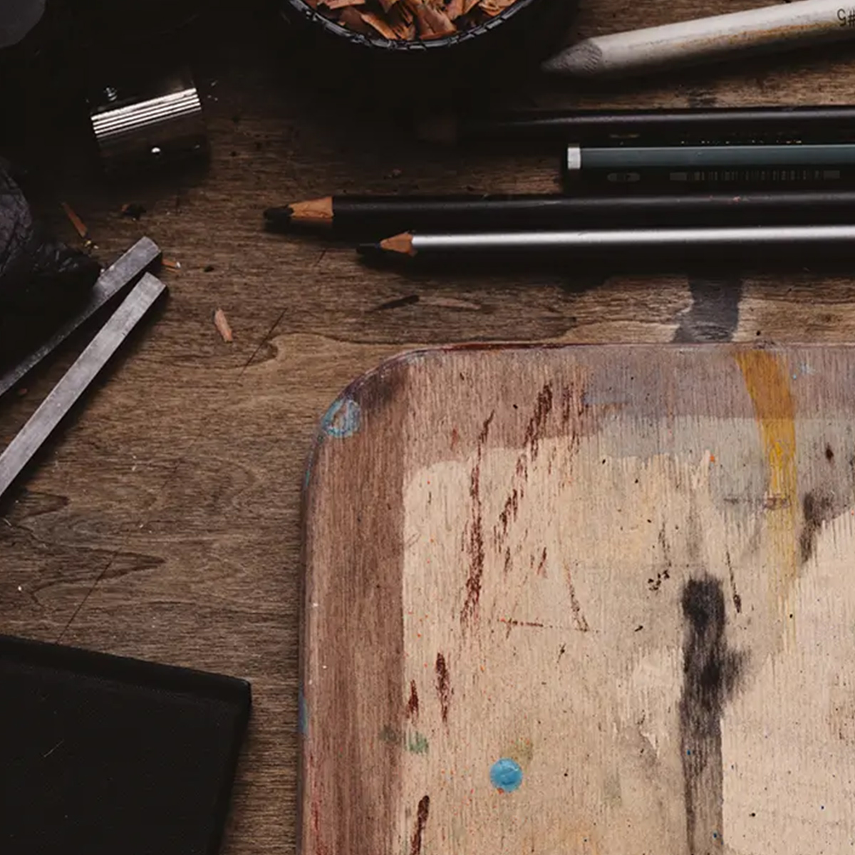 Pencils and other life drawing materials on a studio table