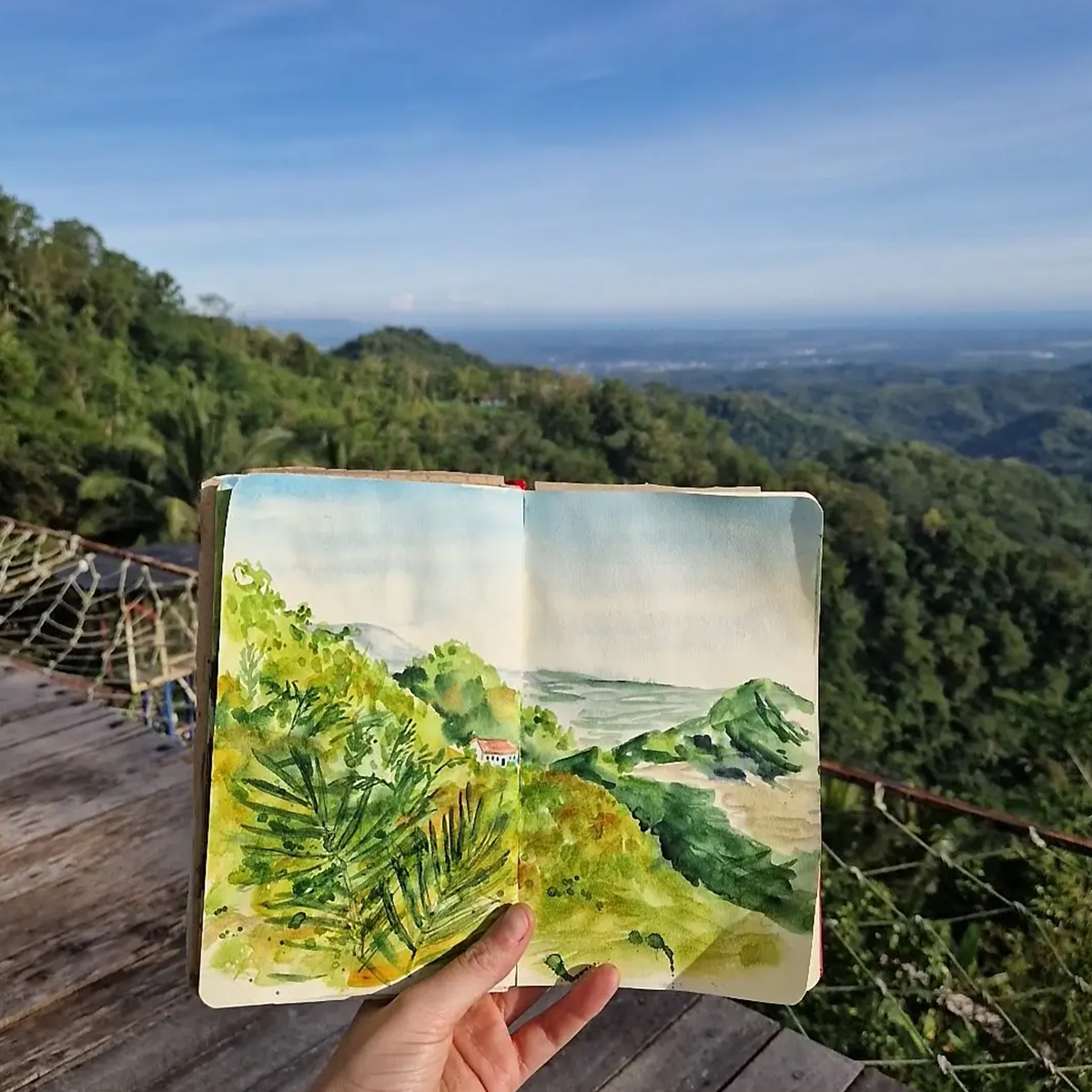 A sketchbook in front of a natural scenery in Yogyakarta, Java
